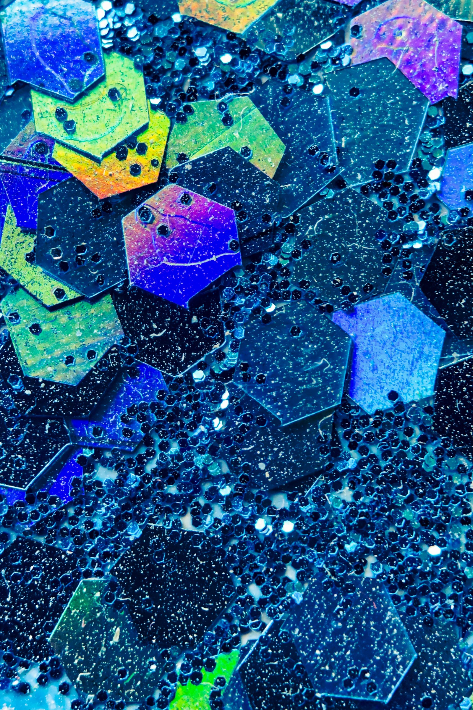 A close up of a bunch of colorful umbrellas on a black surface (hexagon, blue, azure, purple, liquid)