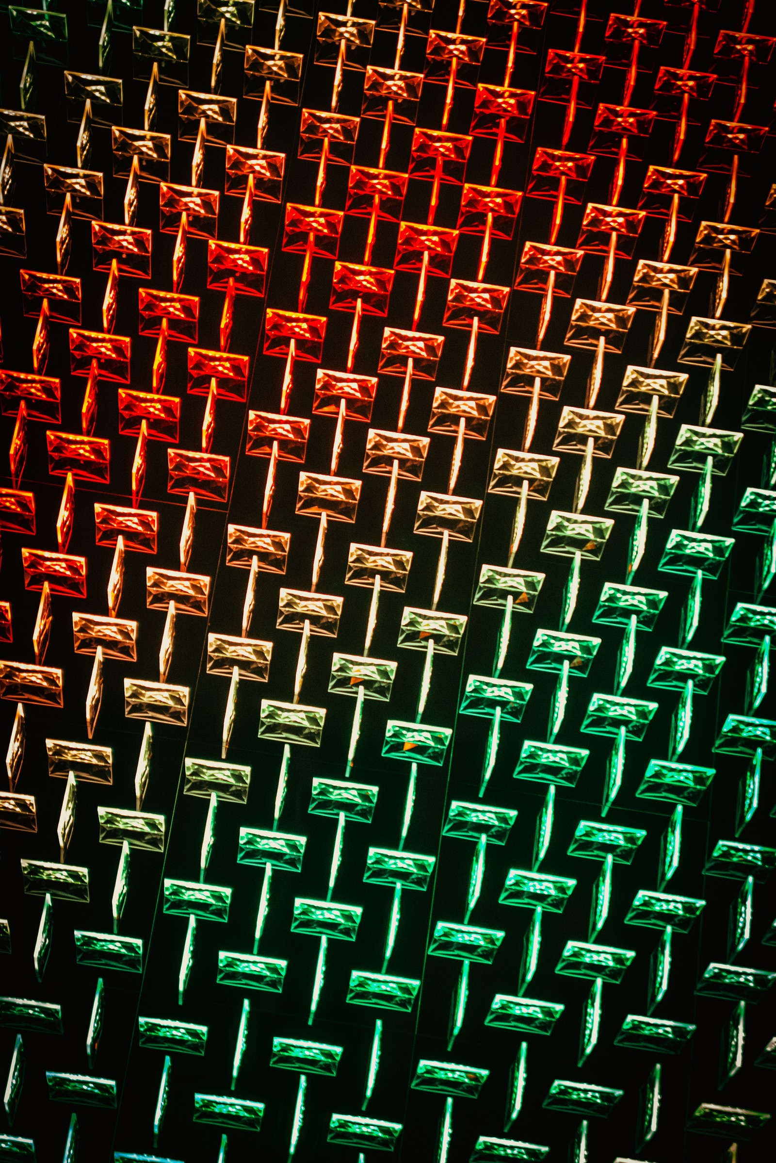 A close up of a traffic light with many different colors (pattern, design, symmetry, apple)