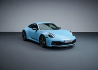 2022 Porsche 911 Carrera T in striking light blue against a minimalist backdrop