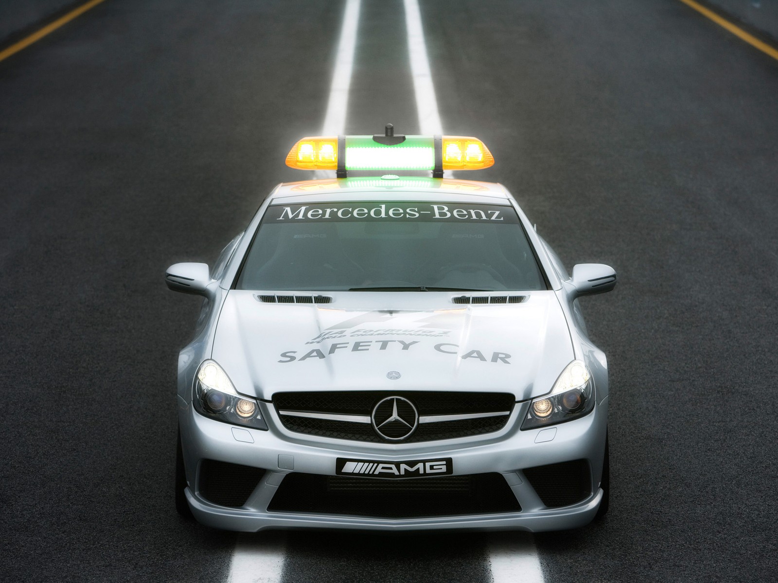 Mercedes benz safety car driving on a road with yellow lights (mercedes benz e class, car, bumper, automotive exterior, mercedes benz)