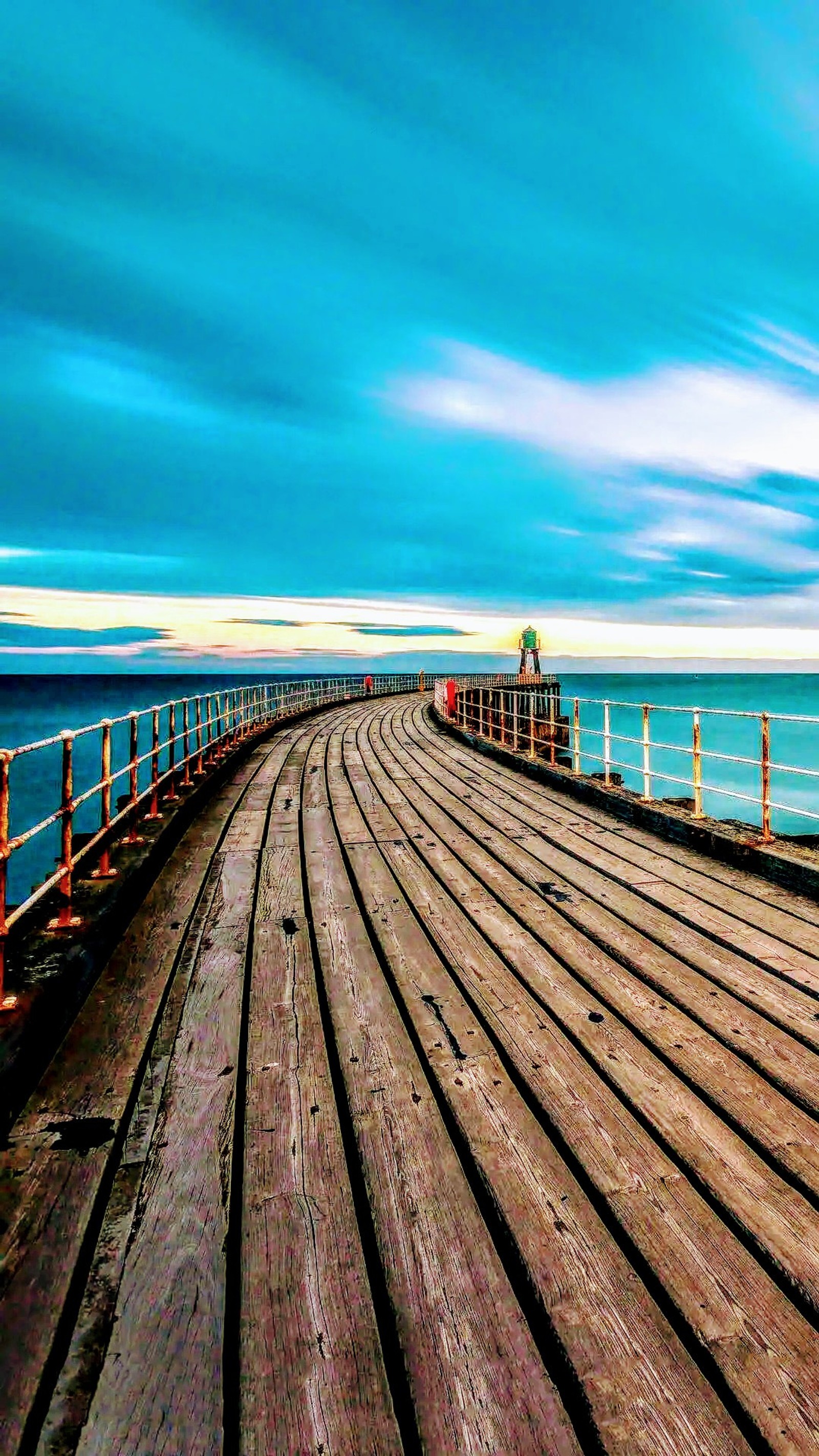 Arafed wooden pier with a bench and a bench on it (bridge, dock, sand, surf)