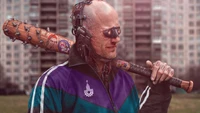 A cybernetic figure in retro sportswear holds a baseball bat, set against an urban backdrop, embodying the gritty aesthetic of Cyberpunk 2077.