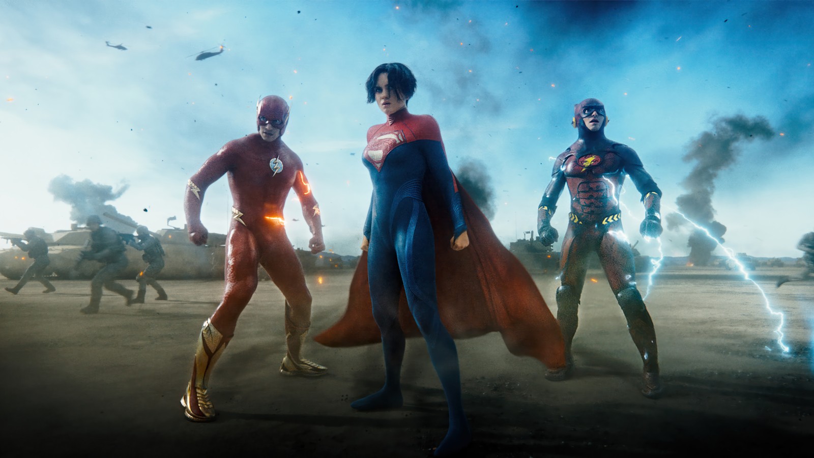 A group of superheros standing in a field with a sky background (supergirl, flash, the flash 2023, movie, dc)