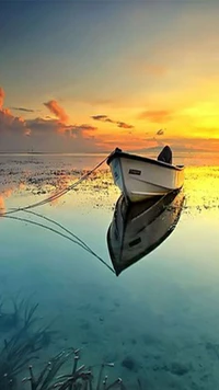 Serene Boat at Sunset Reflecting on Calm Waters