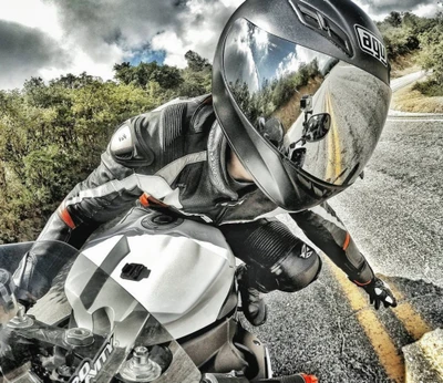 Dynamic biker navigating a winding road on a sleek motorcycle, showcasing skill and adventure.