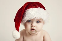 Bebê adorável com um chapéu vermelho de Papai Noel