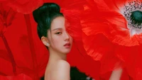 Jisoo from BLACKPINK against a vibrant red floral backdrop.