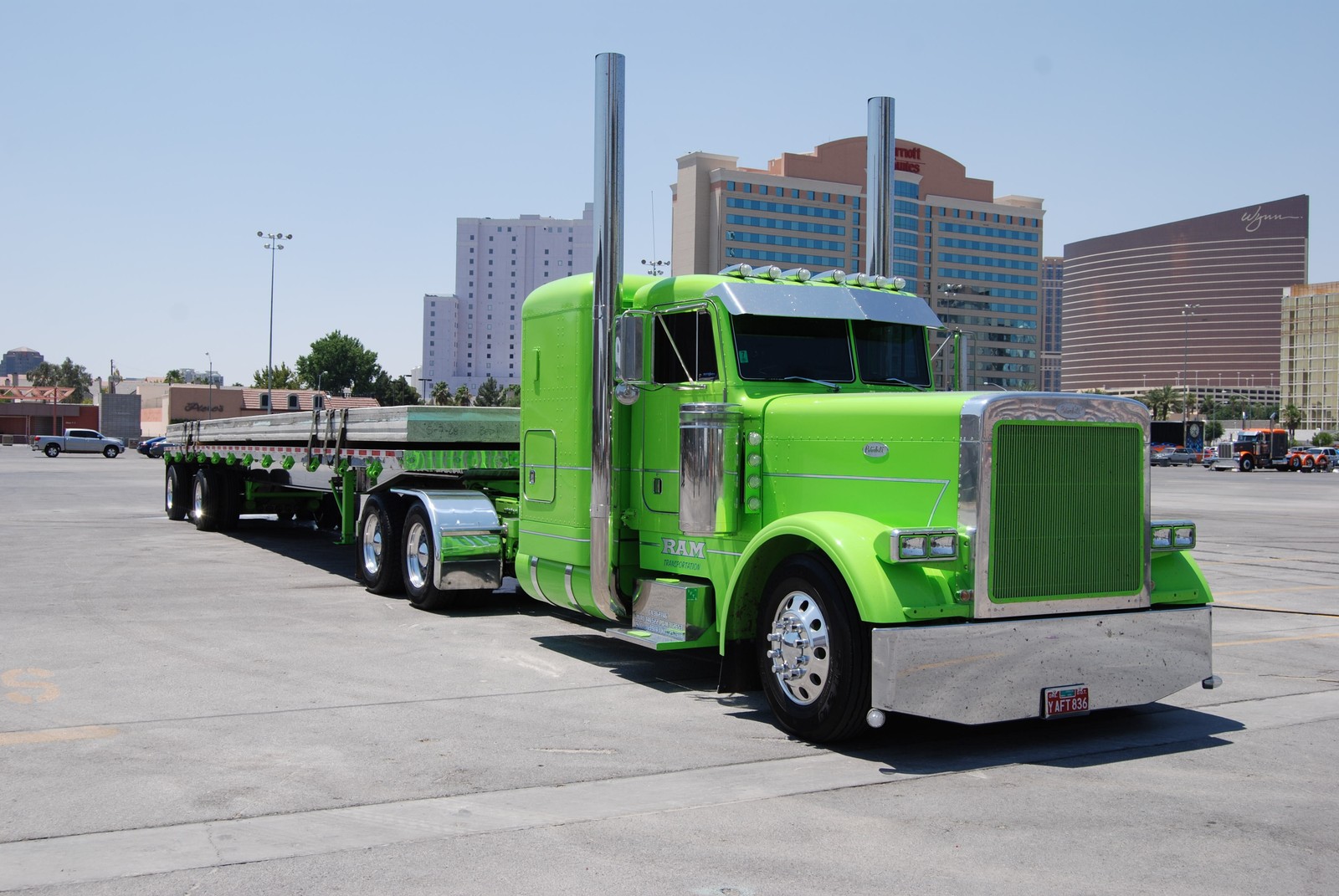 Araf truck parked in a parking lot with a city in the background (peterbilt, car, truck, peterbilt 379, transport)