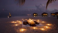 Romantisches Abendessen am Strand unter den Sternen