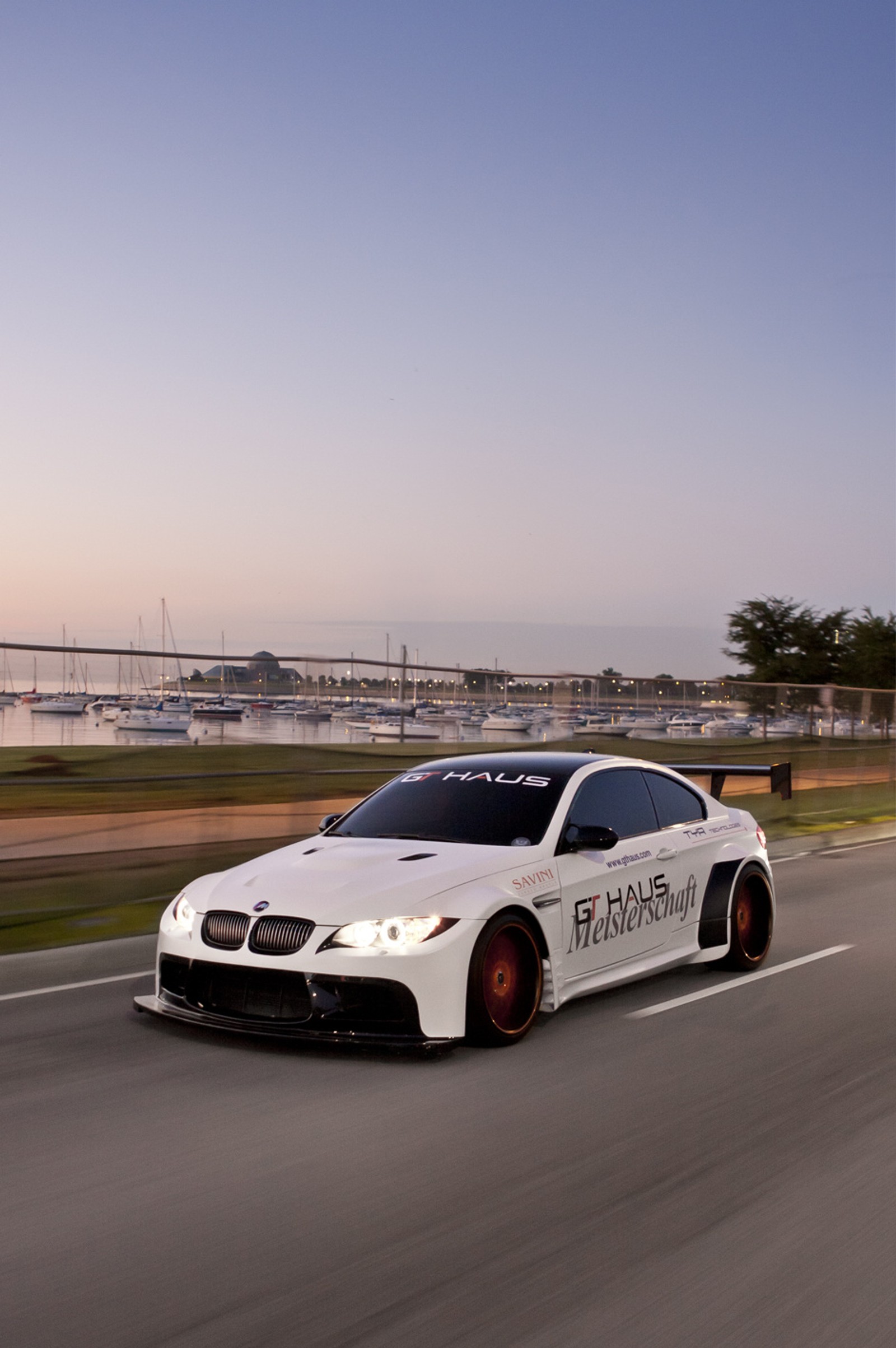 Arafed white car driving down a road with a bridge in the background (bmw, car, new, white)