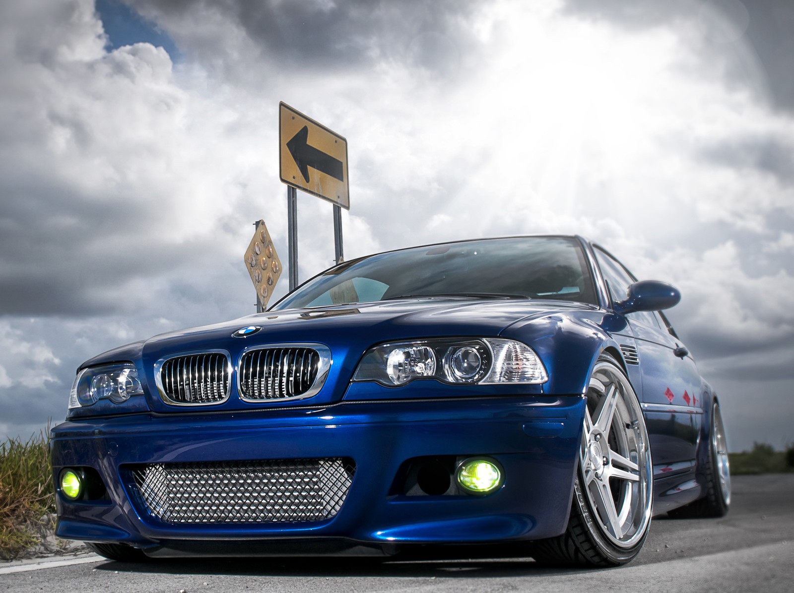 Arafed blue car parked on the side of the road with a sign in the background (bmw, m3)