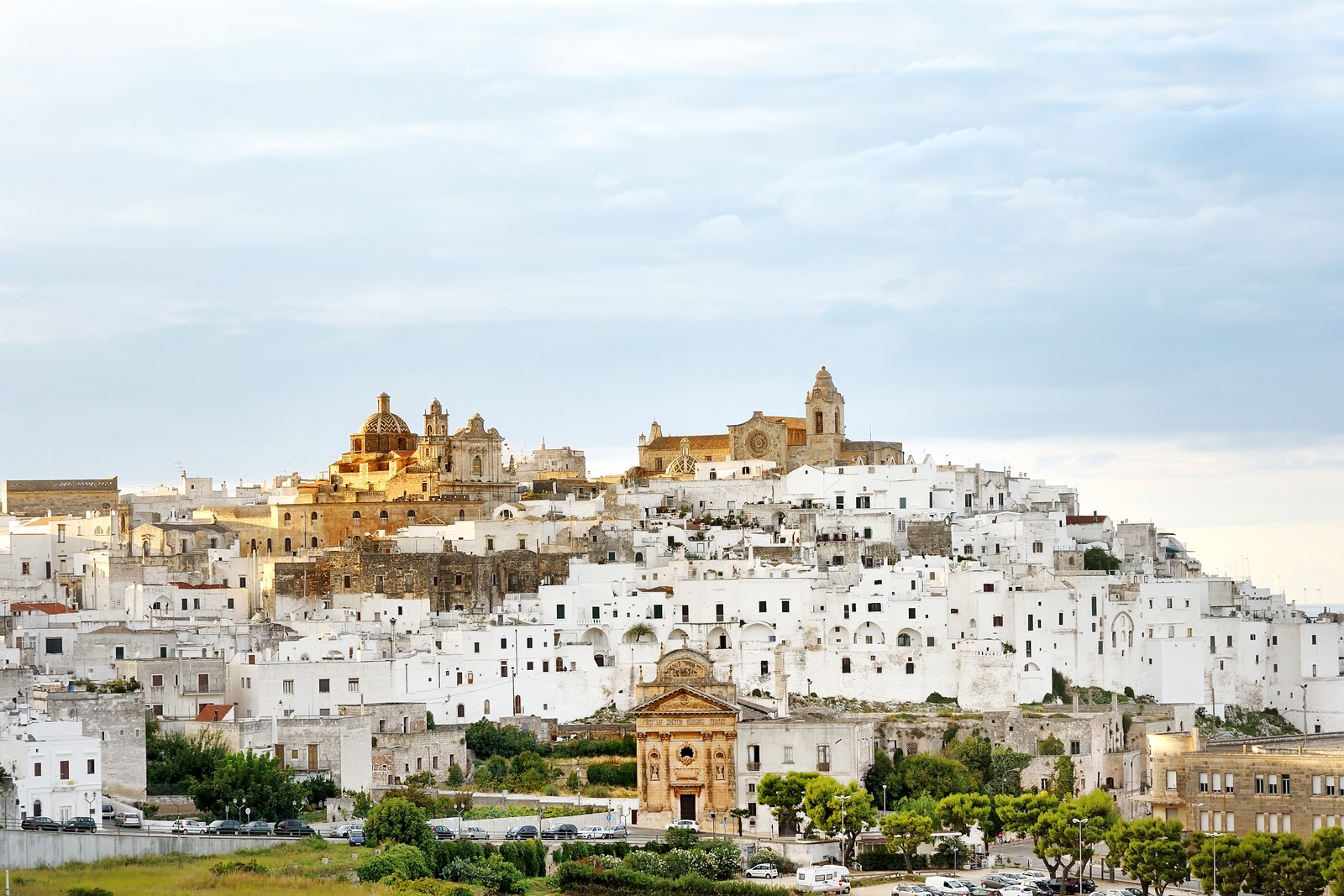 Arafed view of a city with a church and a church tower (historic site, city, village, tourism, villa)