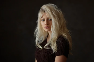 Blond beauty with long, flowing hair and captivating eyes, exuding elegance and charm.