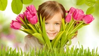 Joyful Child Embracing Pink Tulips in a Lush Green Setting