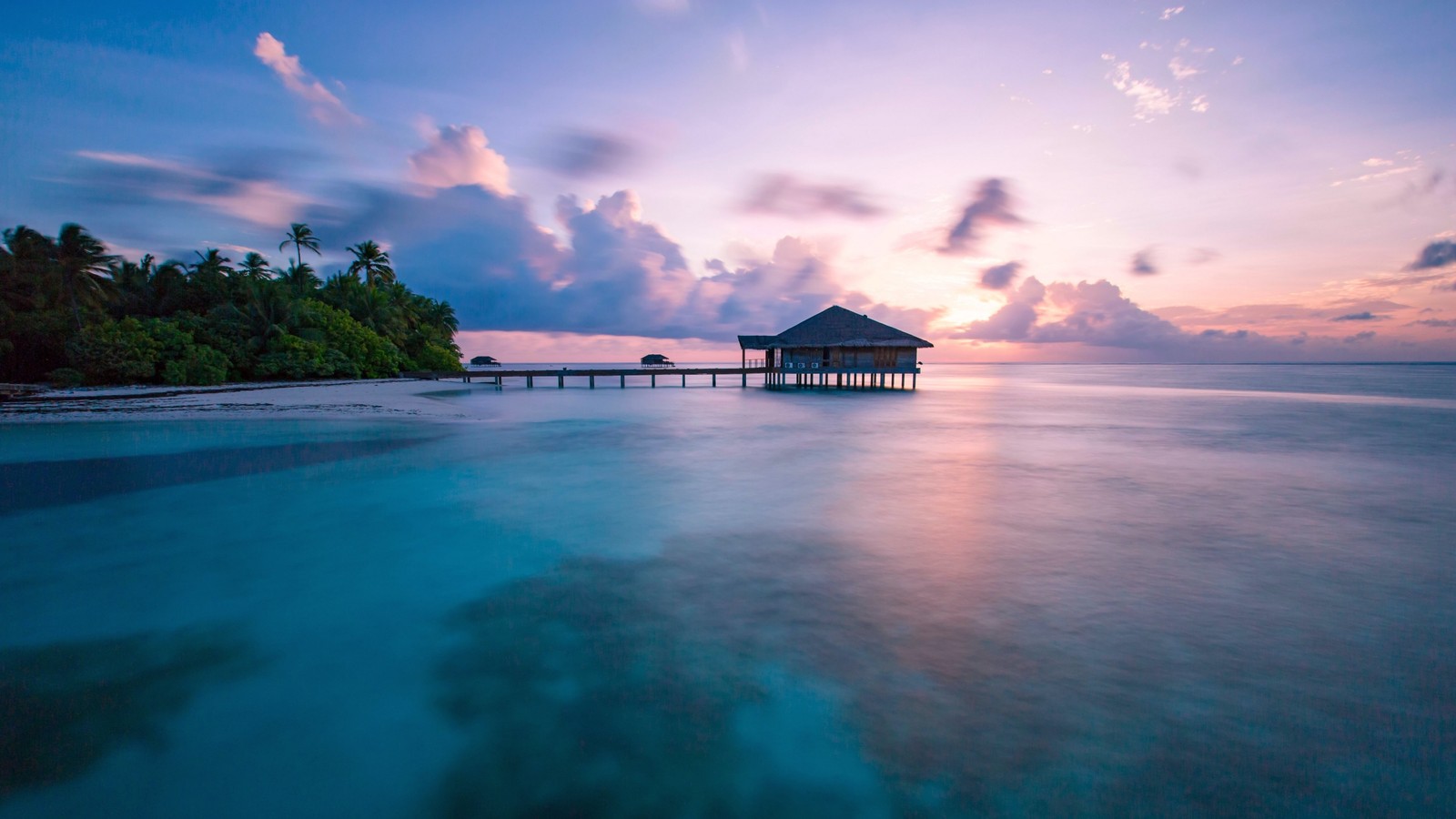 A view of a pier with a hut on it at sunset (maldives, ocean, sea, nature, tropics)