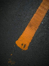 Vibrant Orange Line on Asphalt Texture