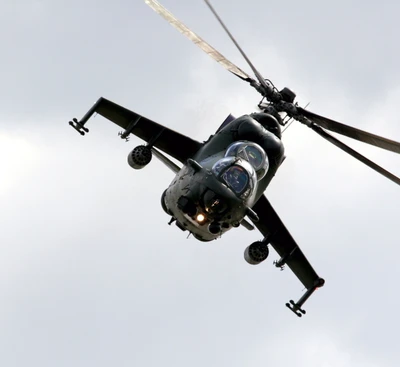 Military Attack Helicopter in Flight Against a Cloudy Sky