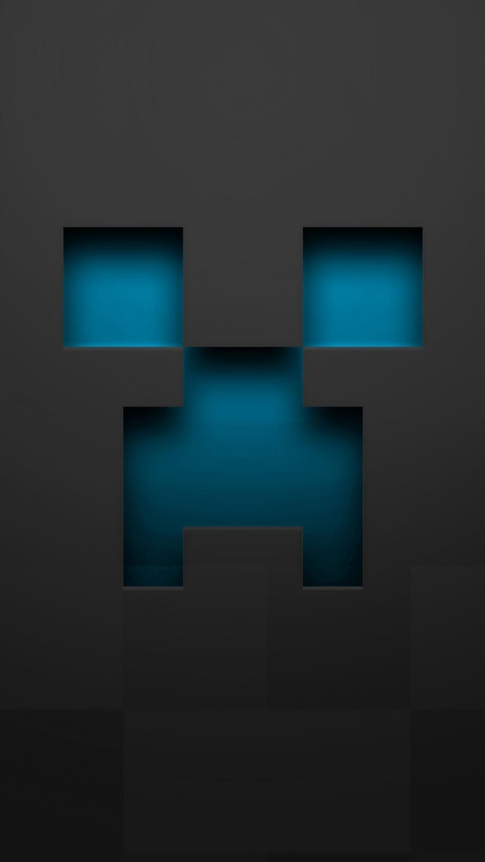 Un gros plan sur un mur noir et bleu avec un visage (creeper, minecraft, mob)