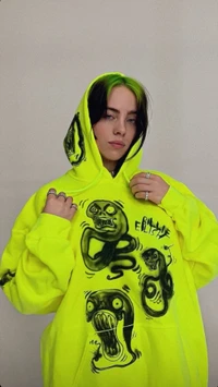 Billie Eilish in a vibrant neon hoodie featuring bold, expressive graphics.