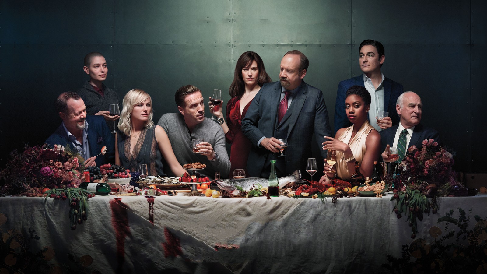 A group of people sitting around a table with wine glasses (damian lewis, showtime, event, meal, supper)