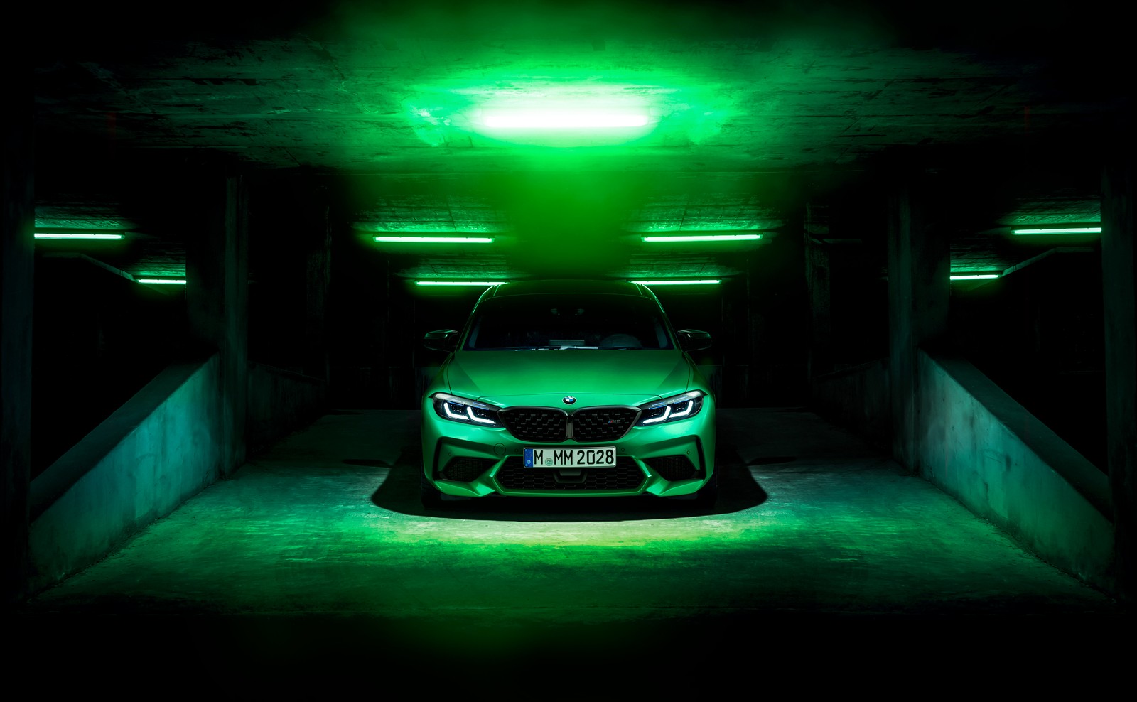 A green car is parked in a dark parking garage (bmw m2, green, dark background, cars, 4k wallpaper)