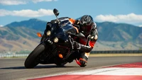 Motorcycle Racer Leaning into a Turn on a Race Track