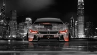 BMW i8 Coupé con reflejos de la ciudad por la noche