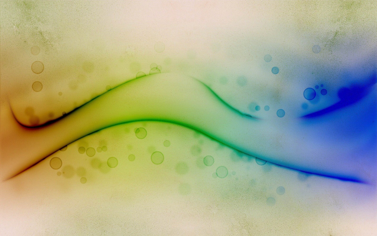 Abstract photograph of a colorful wave with bubbles on a green background (green, water, macro photography)