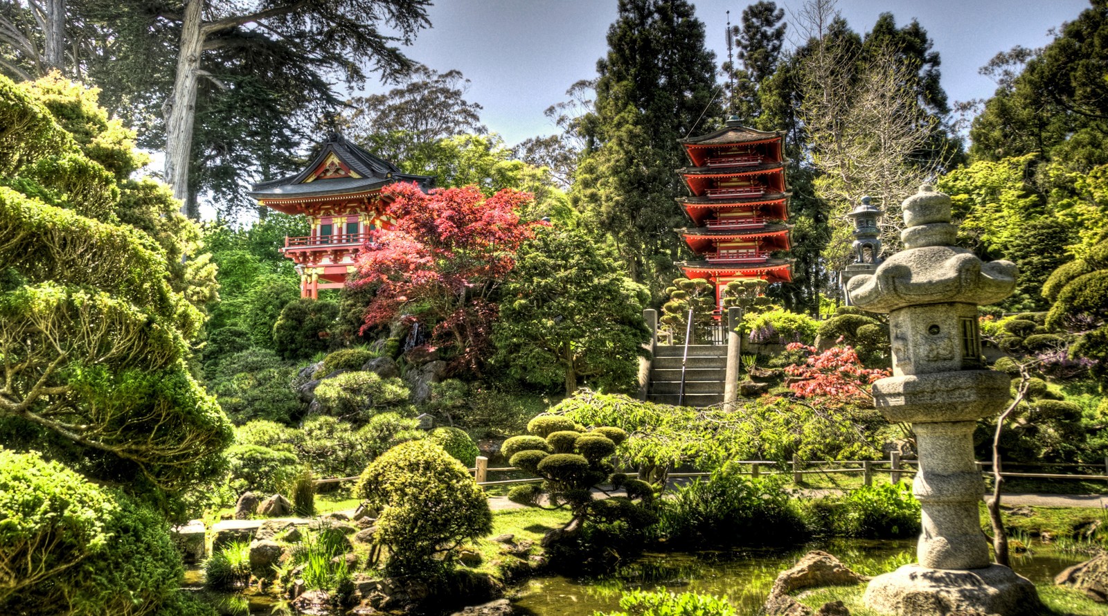 Un gros plan d'une statue en pierre dans un jardin avec une pagode en arrière-plan (jardin japonais, jardin, japon, végétation, nature)