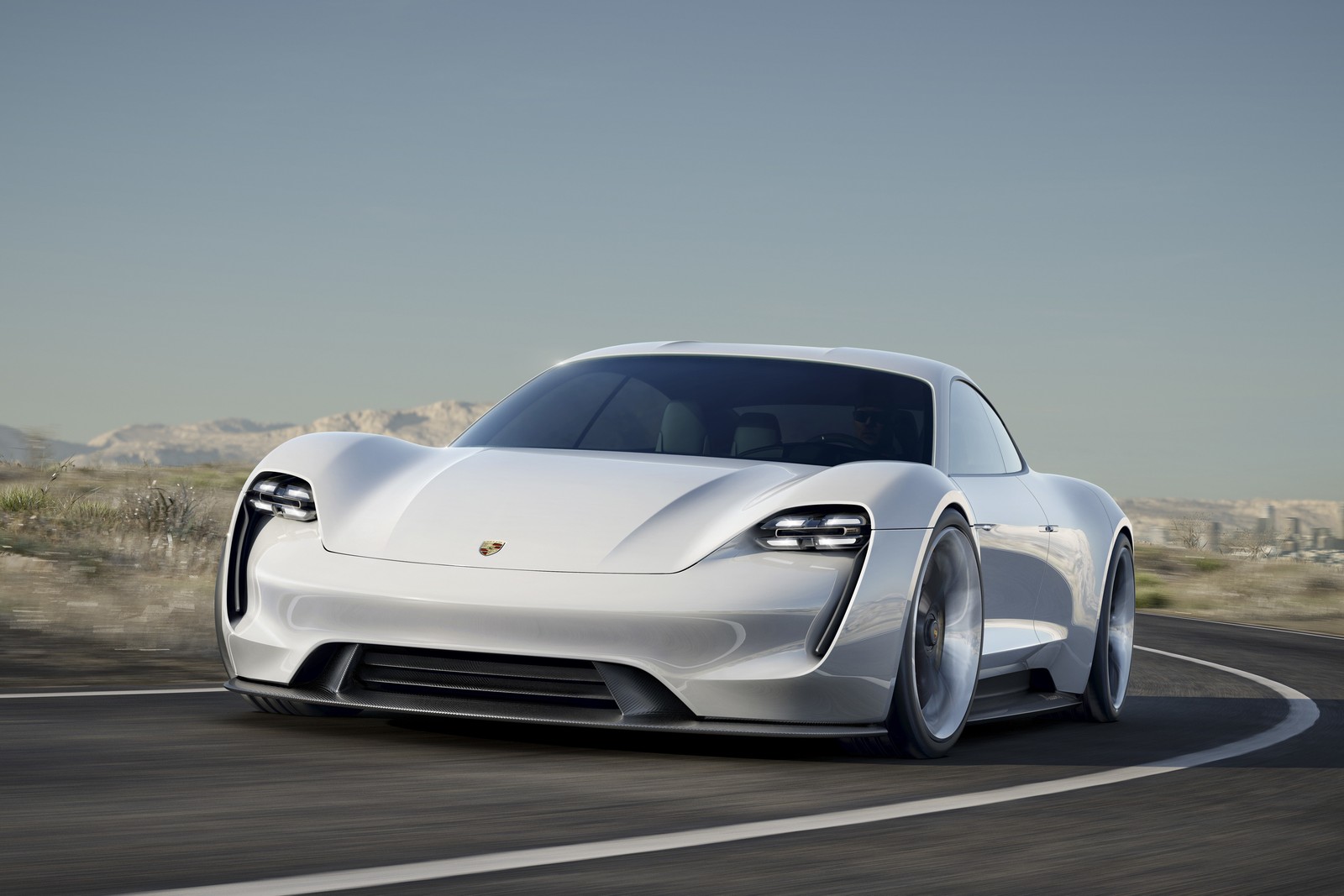 Un coche deportivo blanco conduciendo por una carretera con montañas al fondo (porsche, coche, coche deportivo, tesla model s, supercoche)