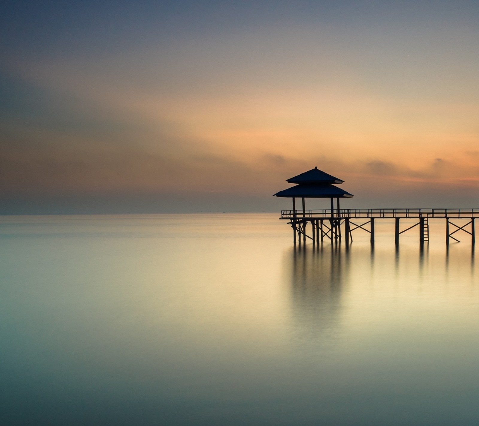 Arafed pier with a hut on it at sunset (landscape, romantic)