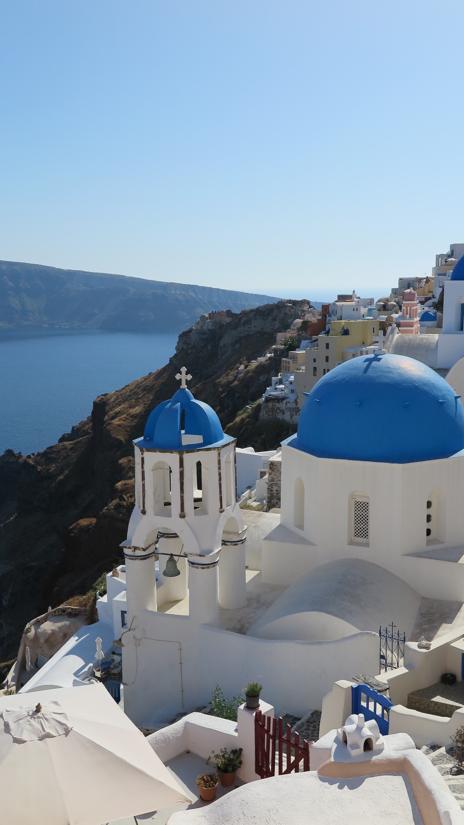 Vista aérea de uma igreja com cúpula azul e telhado azul (cruzeiro, grécia, hd, mediterrâneo, santorini)