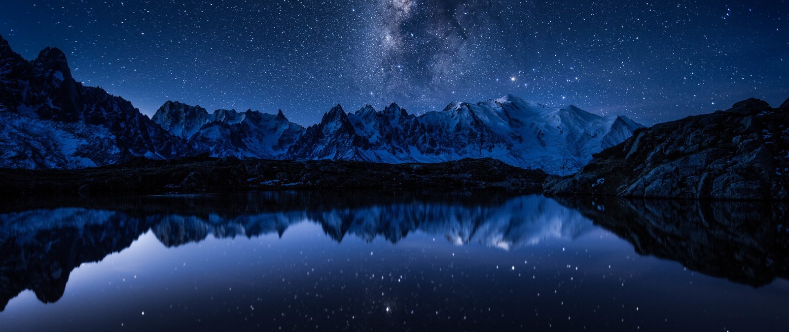 A night sky with stars and a mountain range reflected in a lake (universe, nature, mountain, reflection, atmosphere)