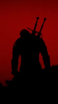 Silhouette of Geralt of Rivia Against a Fiery Red Sky