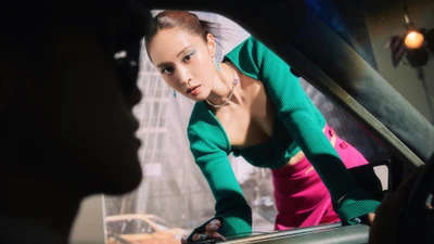 Kwon Yu Ri striking a dynamic pose in a vibrant green sweater and pink skirt, embodying the essence of K-pop and the energy of Girls' Generation's latest album.