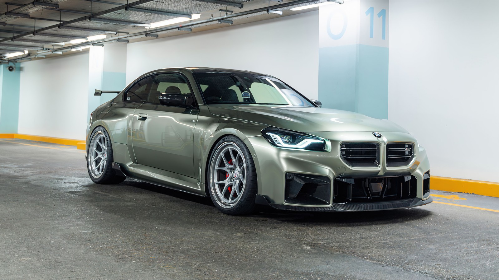 A silver bmw car parked in a parking garage (bmw m2, 2024, cars, 4k wallpaper)