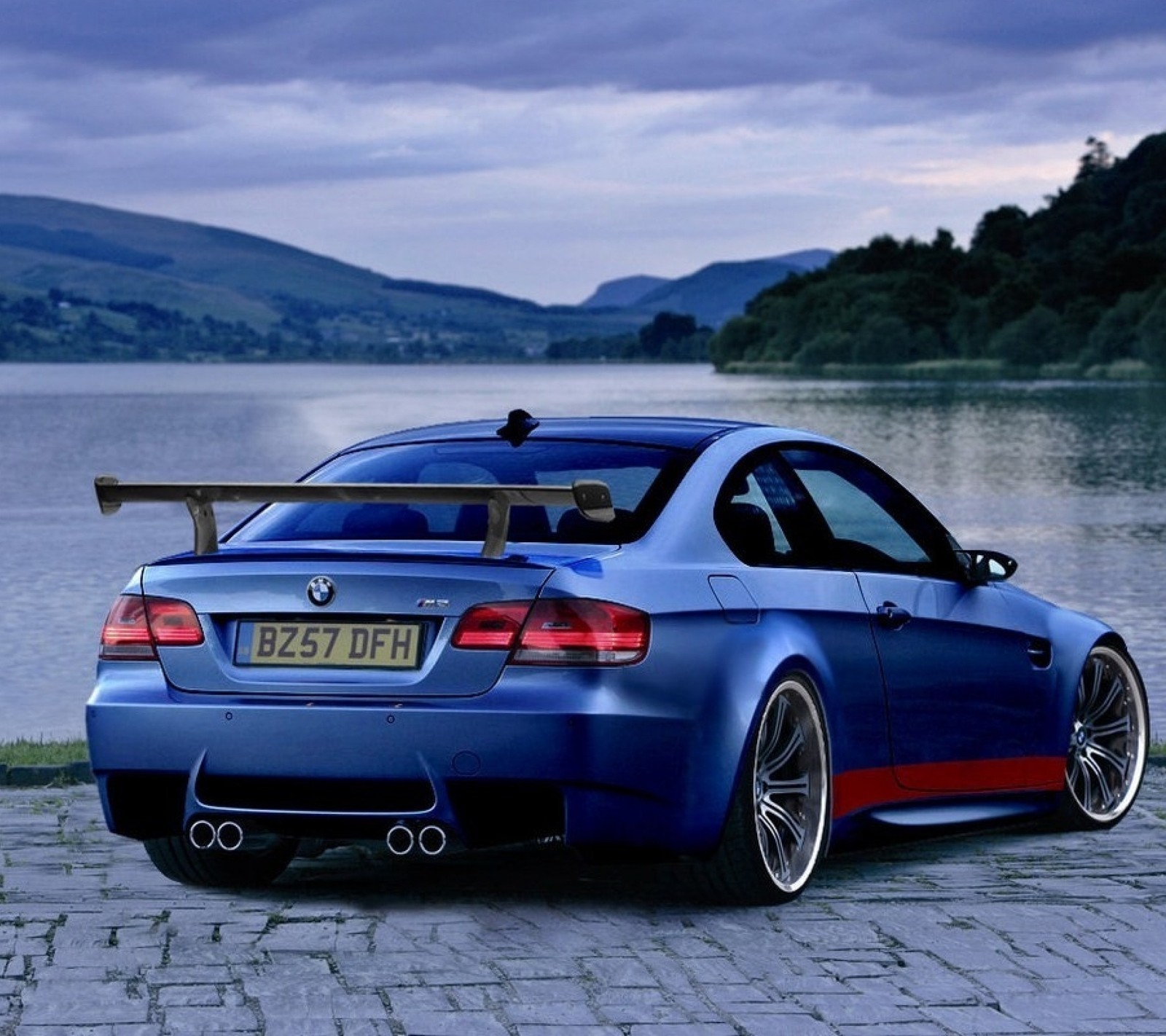 A close up of a blue bmw m3 coupe parked near a lake (auto, bmw, car, vehicle)