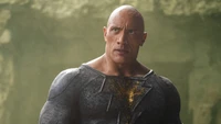 Dwayne Johnson as Black Adam in a powerful pose, showcasing his muscular build and intense expression.