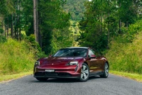 2022 Porsche Taycan in Nature: A Sleek Electric Sports Car on a Scenic Road