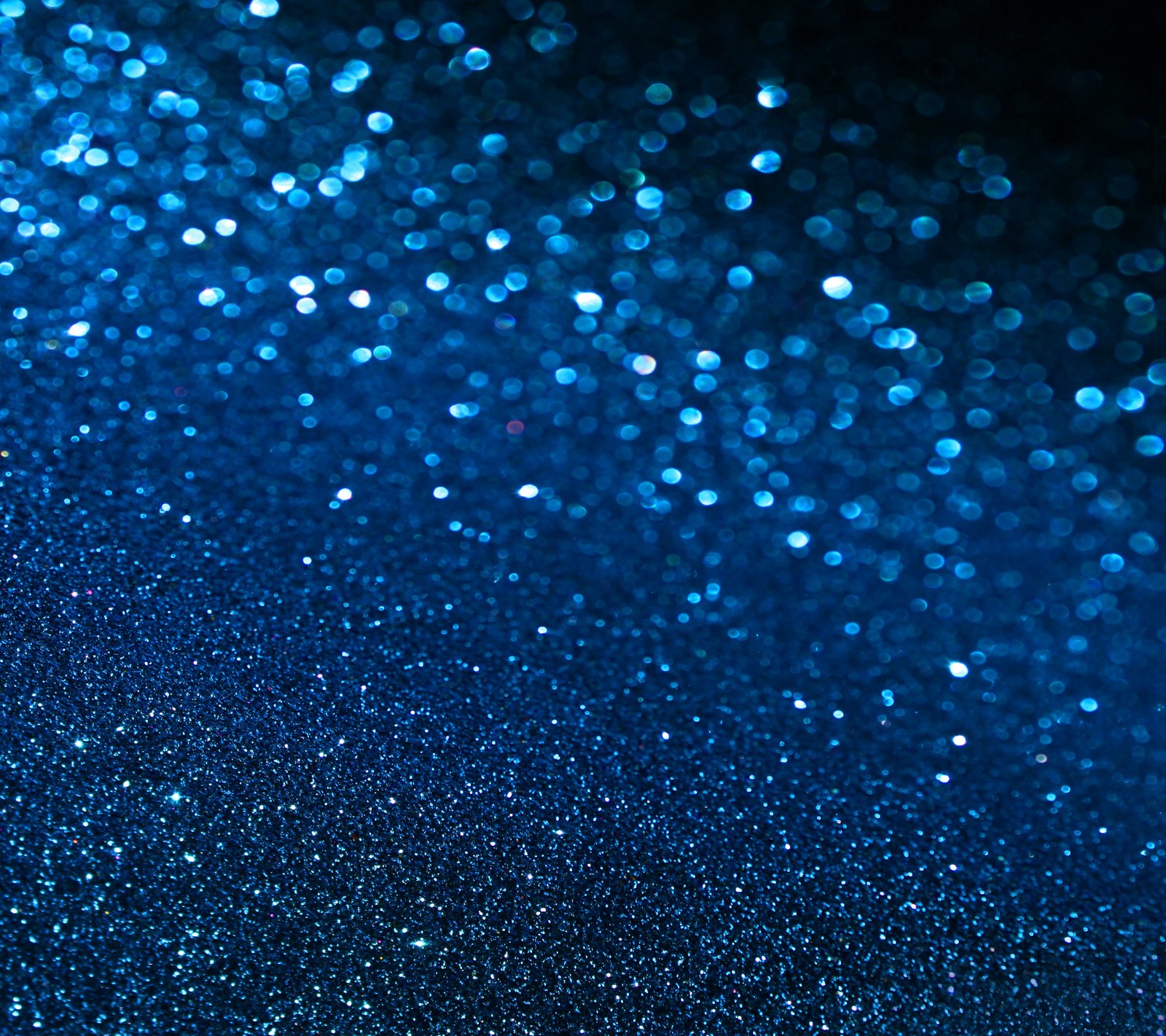 A close up of a blue glittery background with a black background (abstract shiny, background, sparkling blue)