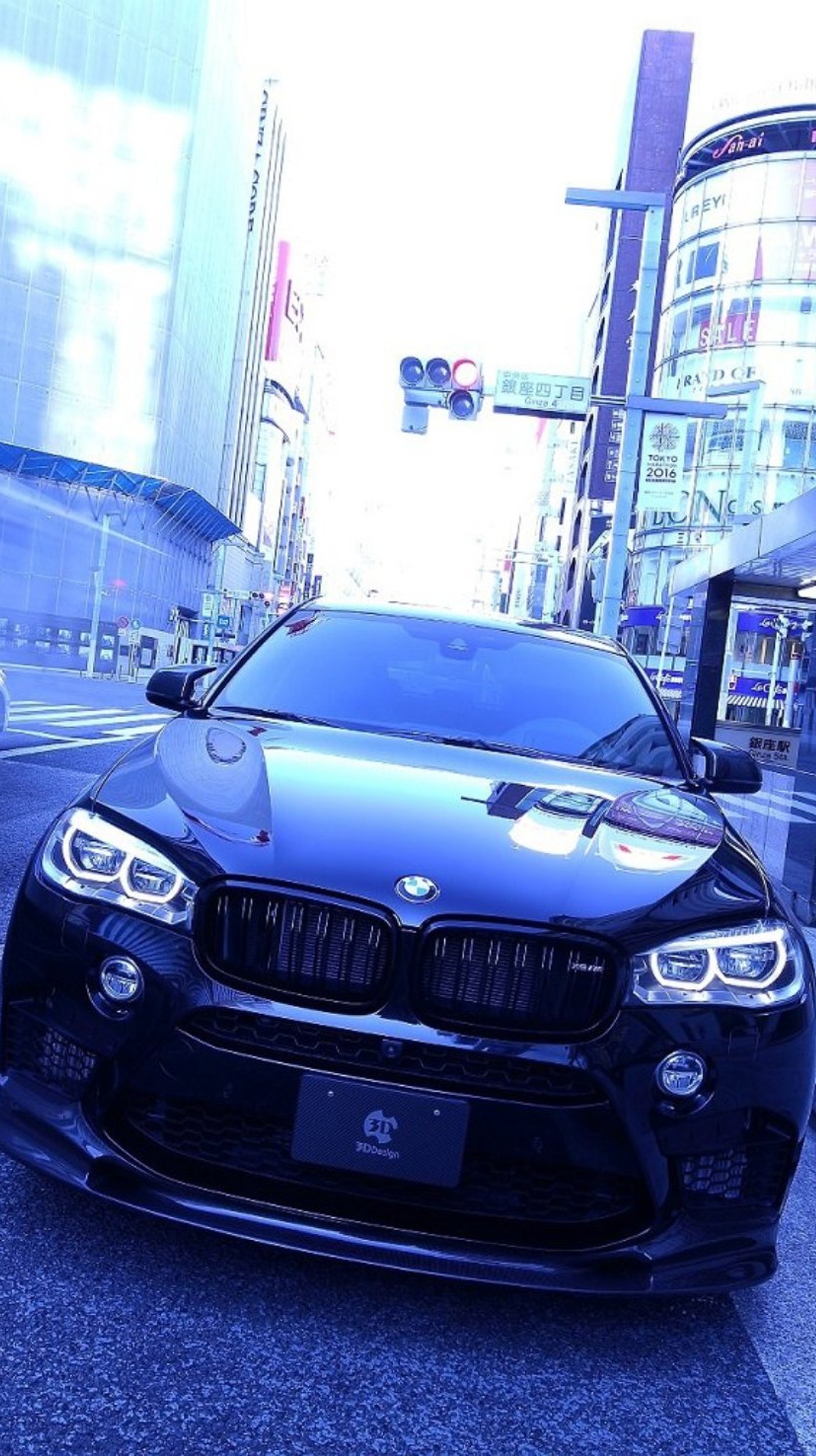 Bmw car parked on the side of the road in a city (black, bmw x6, car, face)