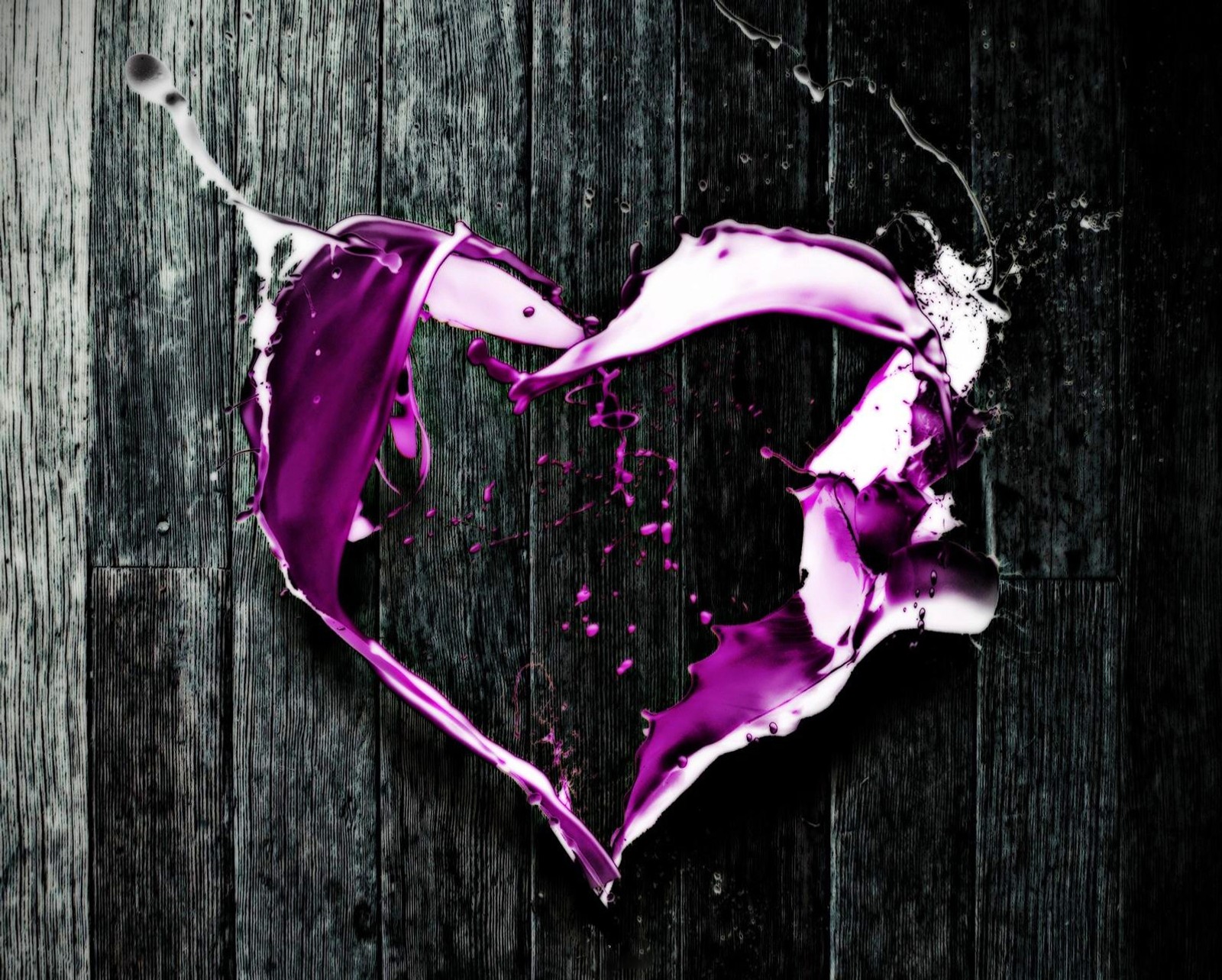 A close up of a broken heart on a wooden surface (background, black and white, color, love, paint)