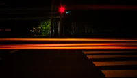 Neon Night: Automotive Light Trails Against a Dark Urban Backdrop