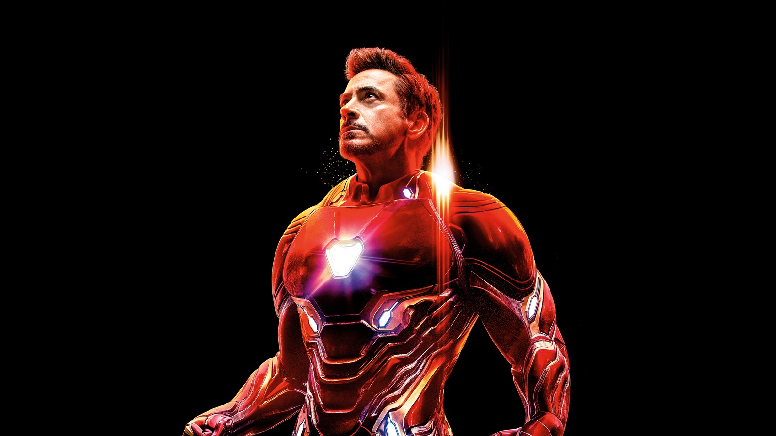 A man in a red suit with a light on his chest (iron man, robert downey jr, avengers infinity war, black background, 5k)