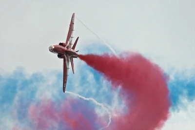 Manœuvre acrobatique dynamique avec des traînées de fumée colorées