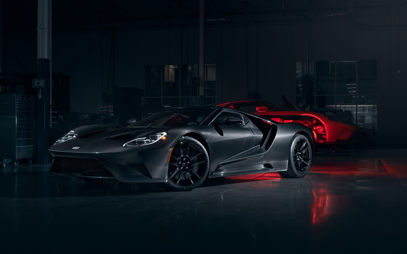 A black sports car parked in a garage with red lights (ford gt, liquid carbon, carbon fiber, 2020, dark)