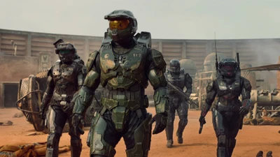 O Master Chief e sua equipe em armadura tática avançam por uma paisagem desolada, incorporando o espírito da série Halo.