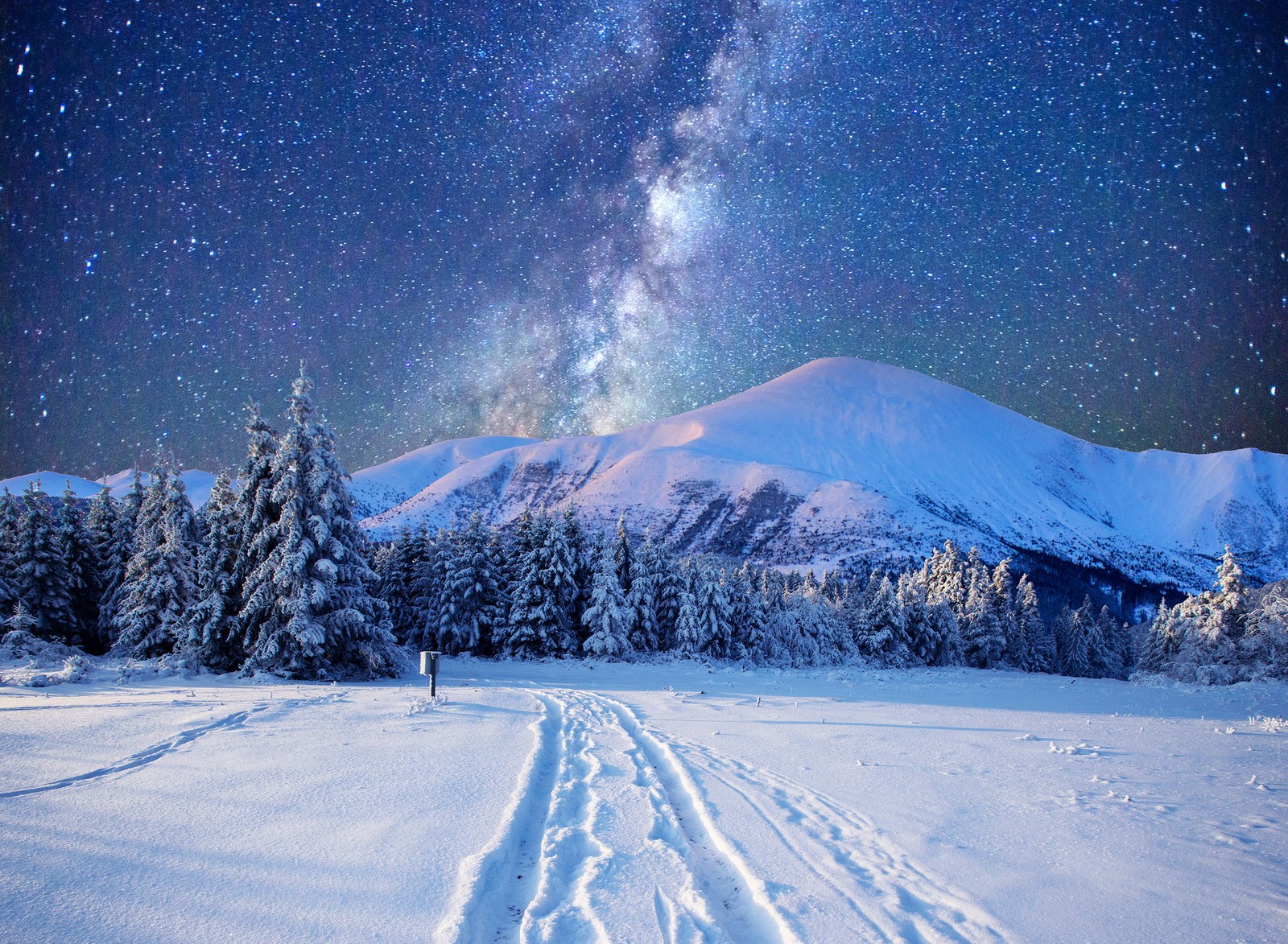 A snowy landscape with tracks in the snow and a milky in the sky (landscape, mountains, nature, night, sky)