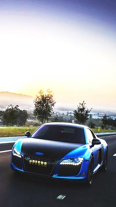 Eleganter Audi R8 in einer atemberaubenden Sonnenuntergangslandschaft auf einer offenen Straße.