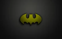 Logo de Batman stylisé en jaune sur un fond sombre.